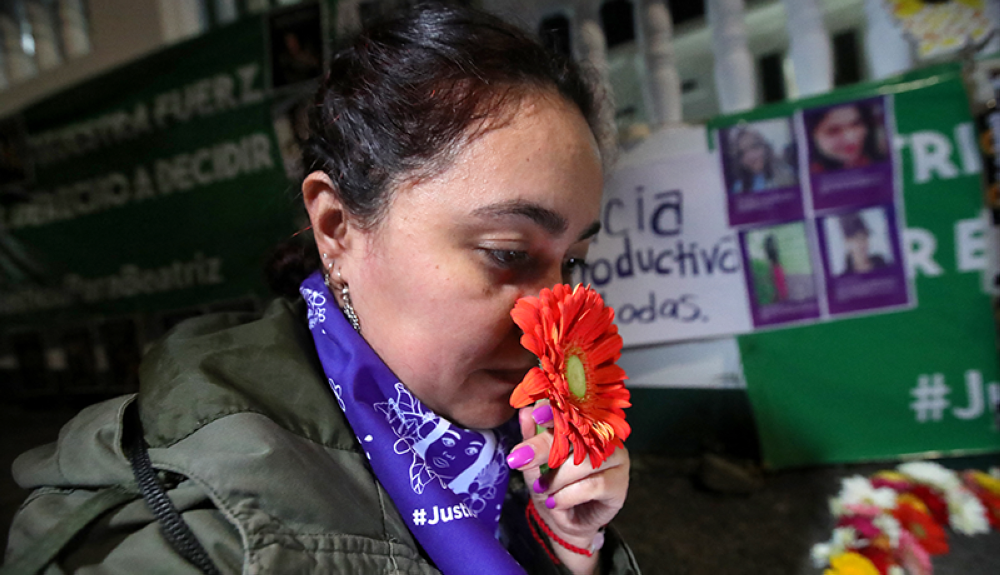 Una mujer asiste a una vigilia en memoria de Beatriz antes de la audiencia en la CIDH que criticó a El Salvador por negarle un aborto a pesar de que los médicos sabían que estaba embarazada de un feto no viable que corría un gran riesgo.AFP
