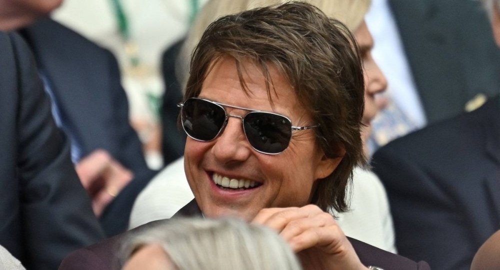 Tom Cruise, quien ya apareció entre el público de los juegos, podría hacer una actuación al estilo de Misión Imposible para este gran evento. Photo by ANDREJ ISAKOVIC / AFP,image_description: