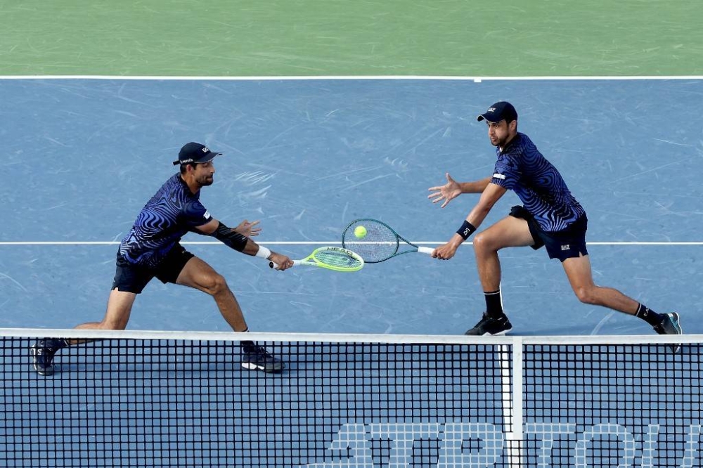 Arévalo y Pavic en acción. Superaron la primera ronda del US Open. / AFP,image_description: