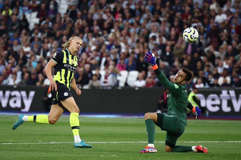 Erling Haaland bate al portero Lukasz Fabianski en la victoria del City sobre el West Ham. / AFP,image_description: