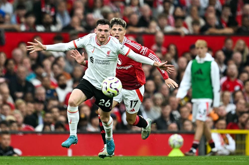 Andrew Robertson, del Liverpool, defiende la pelota ante Alejandro Garnacho, del United. / AFP,image_description: