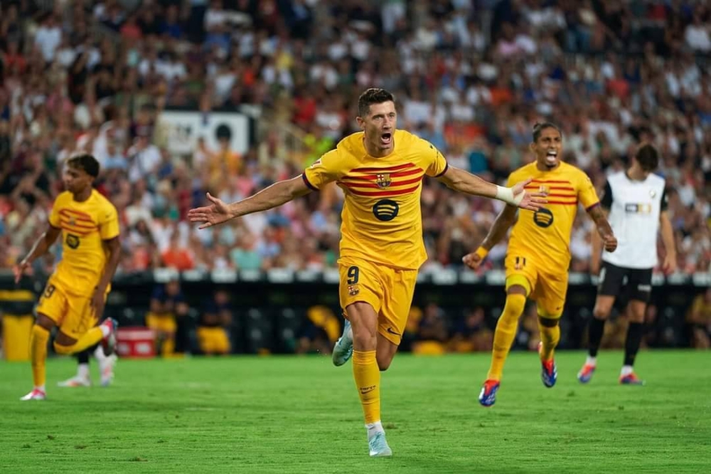 Robert Lewandowski celebra con la camisa del Barcelona. ,image_description: