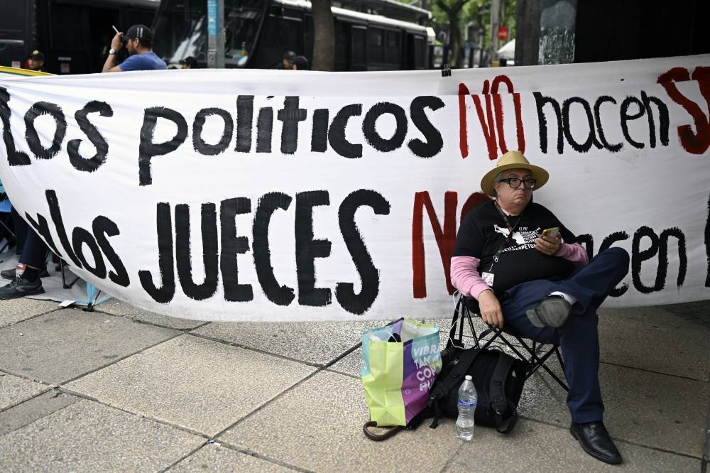 Un trabajador judicial participa en una protesta contra la reforma judicial propuesta por el gobierno frente al Senado de México en la Ciudad de México el 5 de septiembre de 2024 /Alfredo Estrella AFP.,image_description: