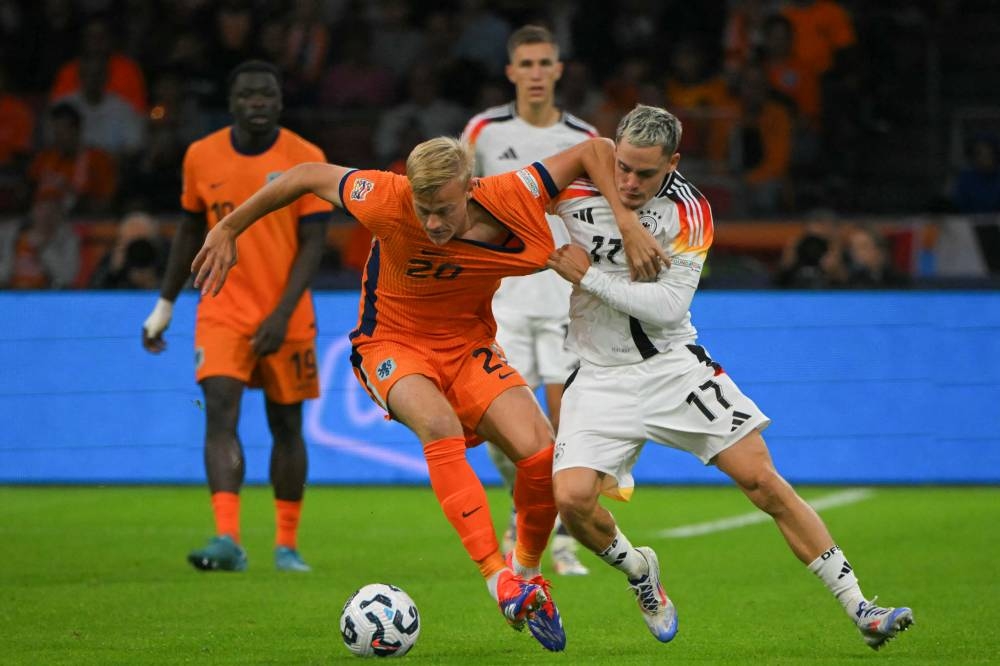 La lucha entre el neerlandés Jan Paul van Hecke y el alemán Florian Wirtz. / AFP,image_description: