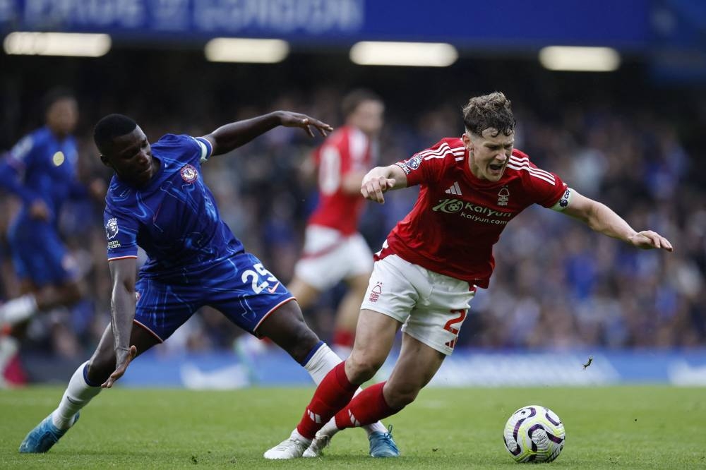 El ecuatoriano Moises Caicedo, del Chelsea, intenta frenar a Ryan Yates, del Nottingham Forest. / AFP,image_description: