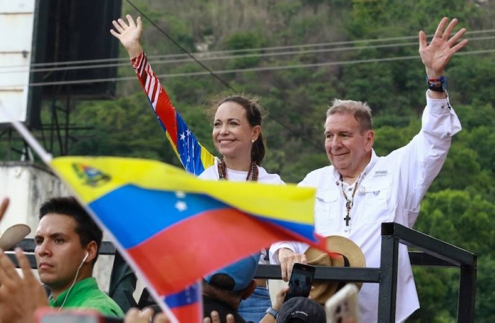 La líder de la oposición venezolana, María Corina Machado y el candidato presidencial opositor, Edmundo Gonzalez, durante un acto de la pasada campaña electoral./ AFP,image_description: