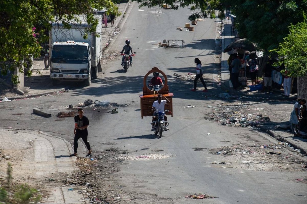 En Haití, la gente huye de los barrios luego de que bandas armadas aterrorizaran zonas en Puerto Príncipe, el 26 de octubre. / AFP.,image_description: