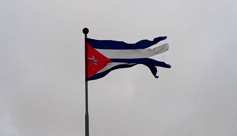 Los fuertes vientos destruyeron parcialmente una bandera ubicada en La Habana. / AFP 