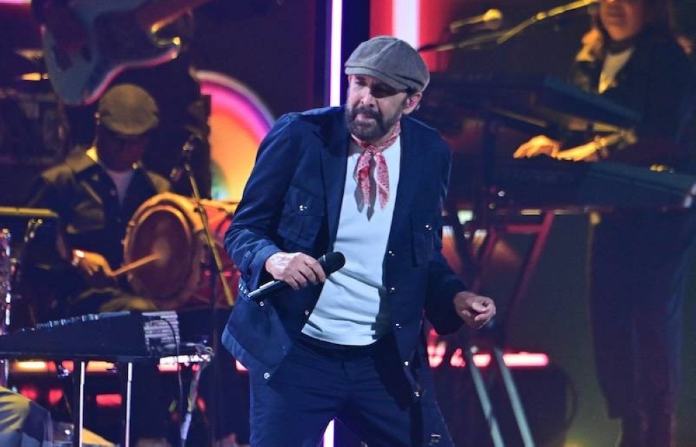 El cantante dominicano  Juan Luis Guerra actúa en la gala de los Grammys anoche en el Kaseya Center en Miami, Florida/ AFP,image_description: