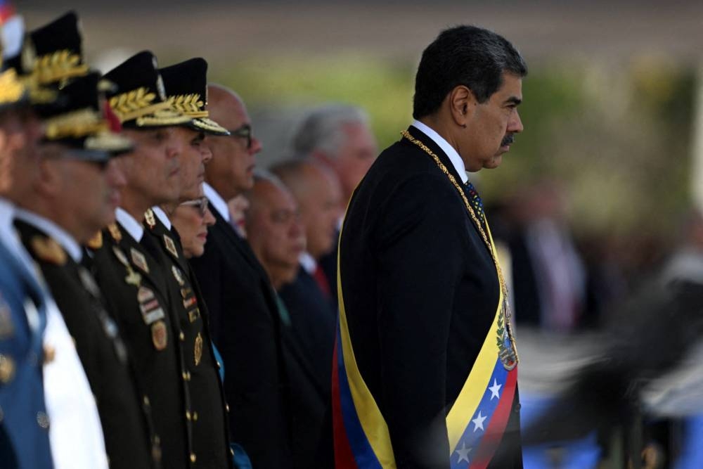 Venezuelas President Nicolas Maduro gestures during a ceremony at Fort Tiuna military base within the presidential inauguration in Caracas on January 10, 2025. Maduro, in power since 2013, took the oath of office for a third term despite a global outcry that brought thousands out in protest on the ceremonys eve. Photo by Juan BARRETO / AFP,image_description: