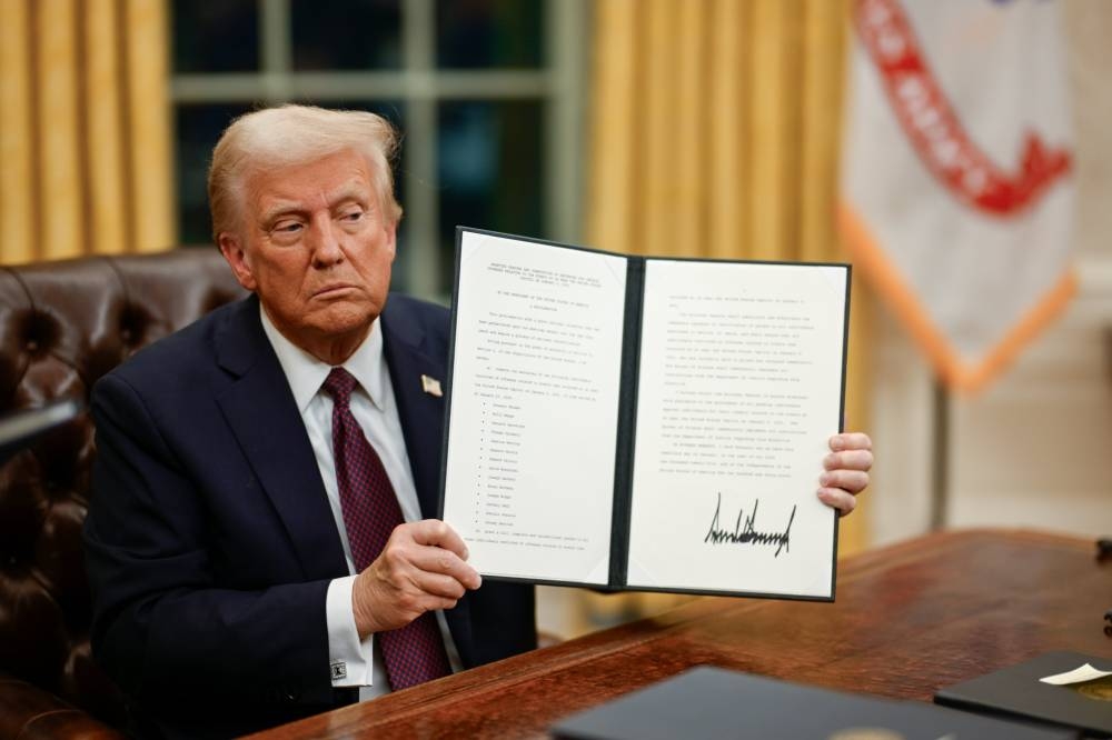 Trump muestra su firma en las primeras órdenes ejecutivas. / Tomada de la Casa Blanca. 